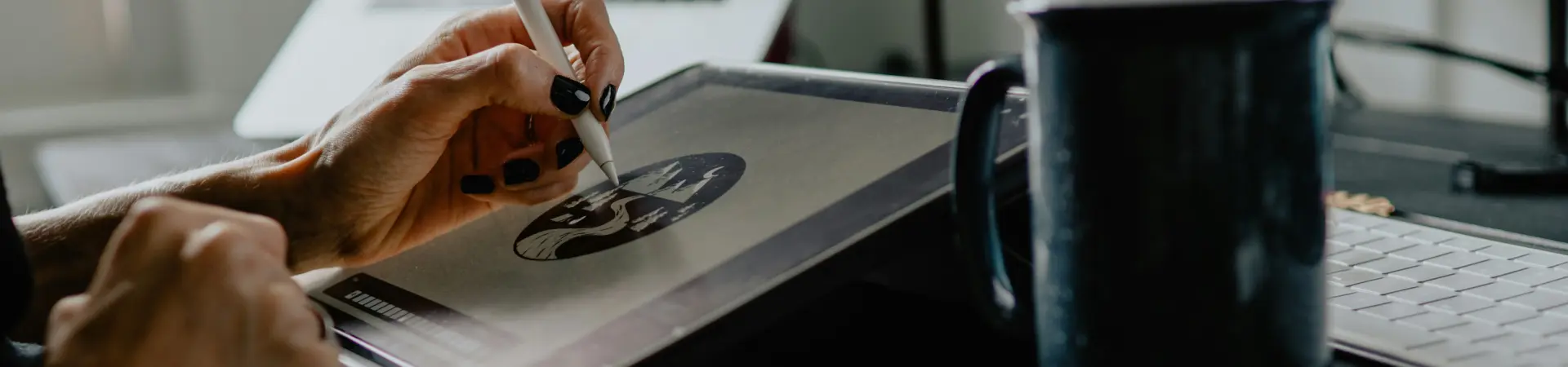 A Graphic Artist at The Columbian Draws on a Tablet