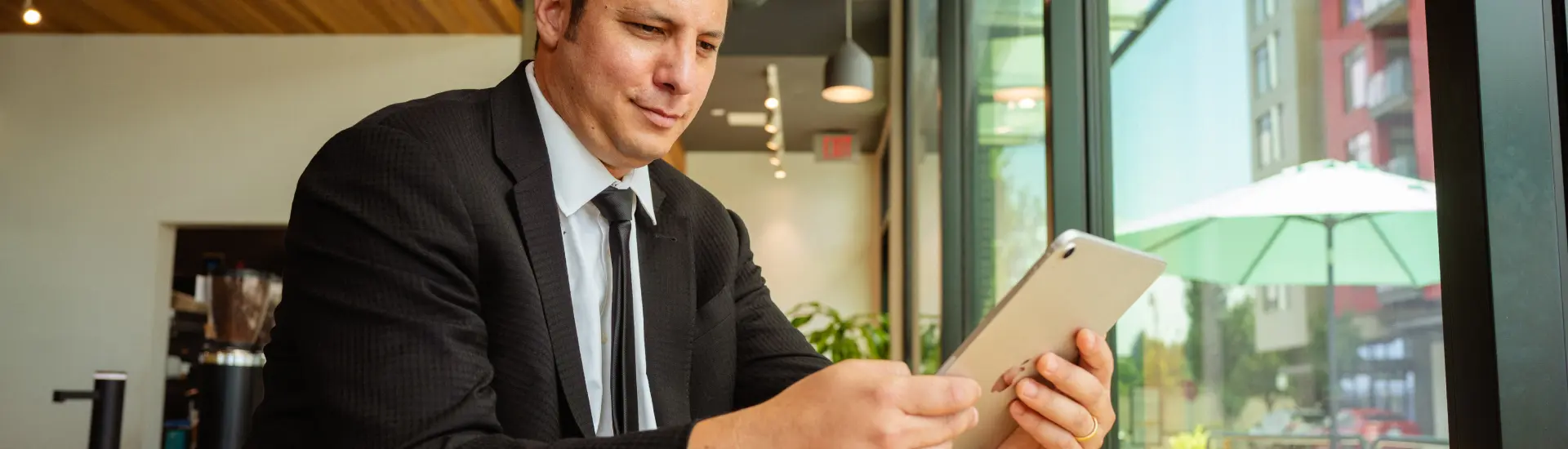 Man reading The Columbian on tablet in Vancouver Waterfront coffee shop